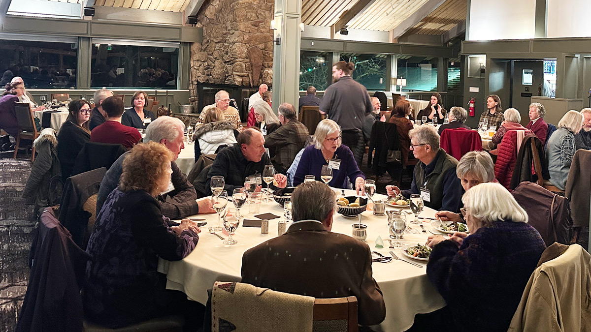people around tables in a large room